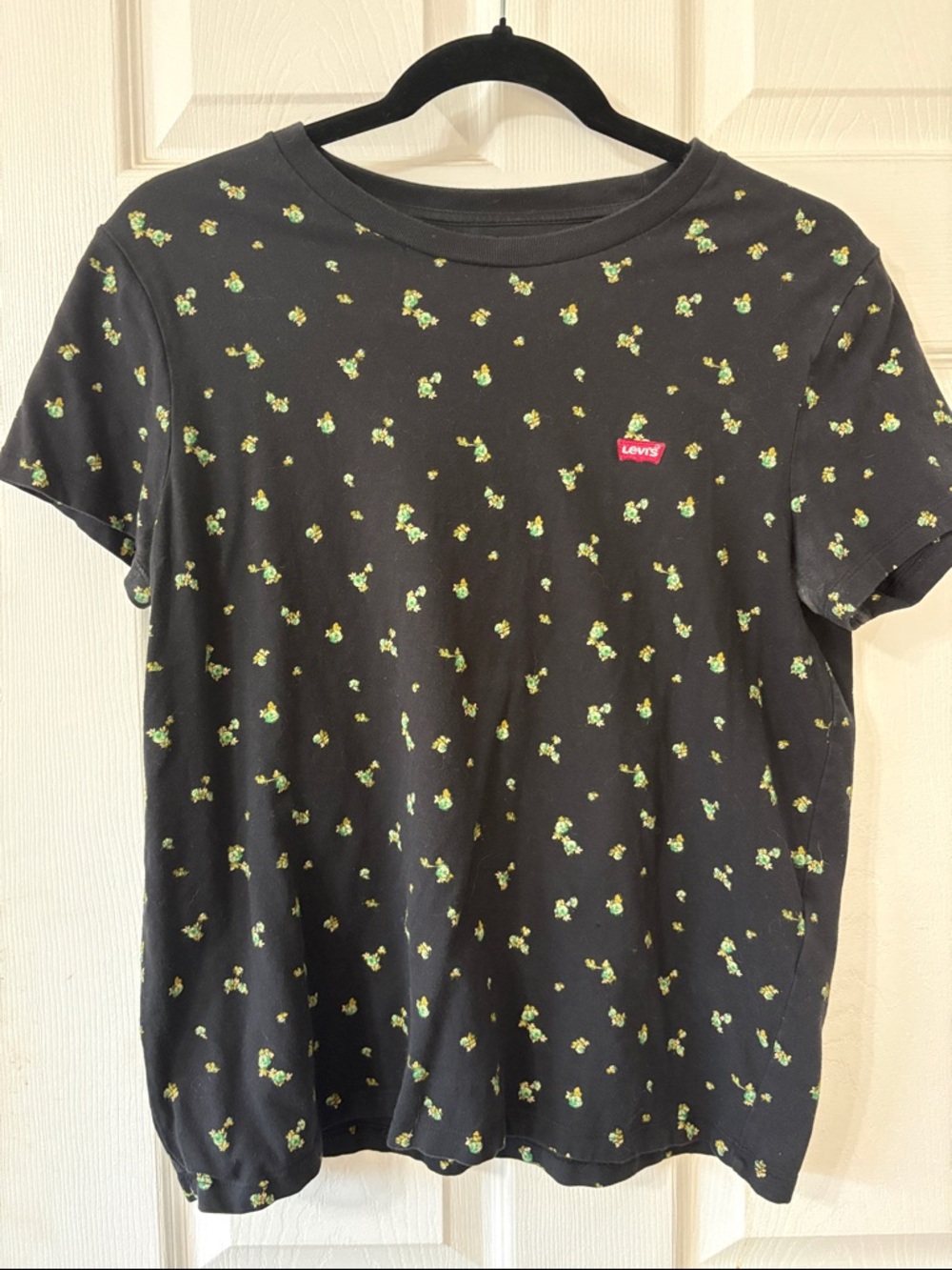 Levi's Black Tee with Small Green Floral Motif and Red Logo